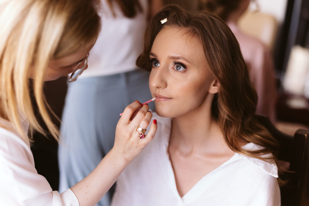 a woman putting on makeup