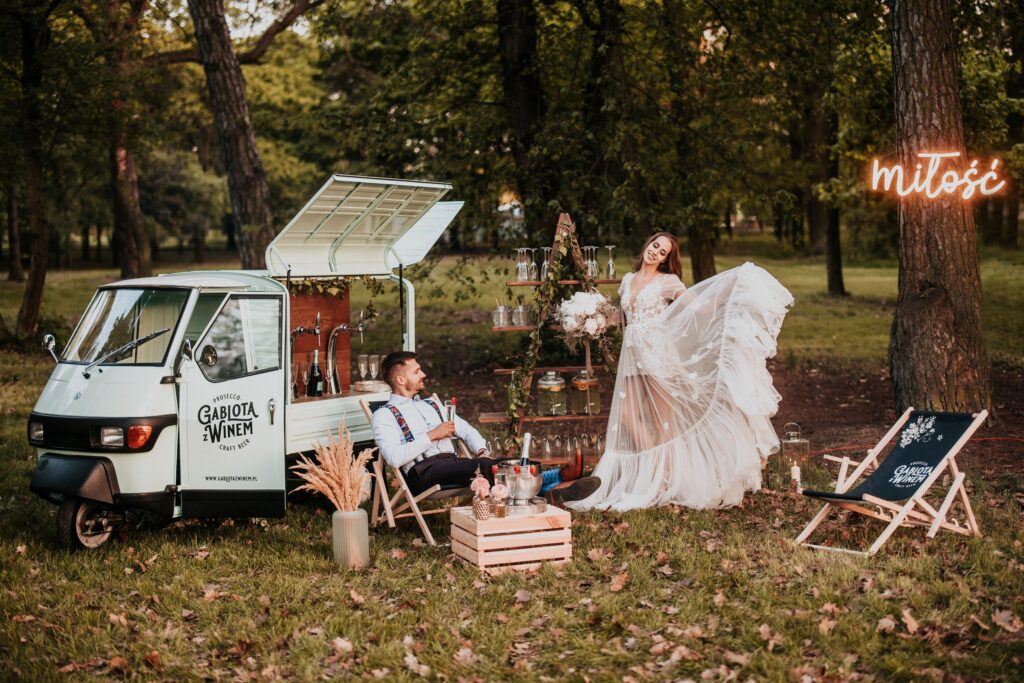 a man and woman in a white dress in front of a van