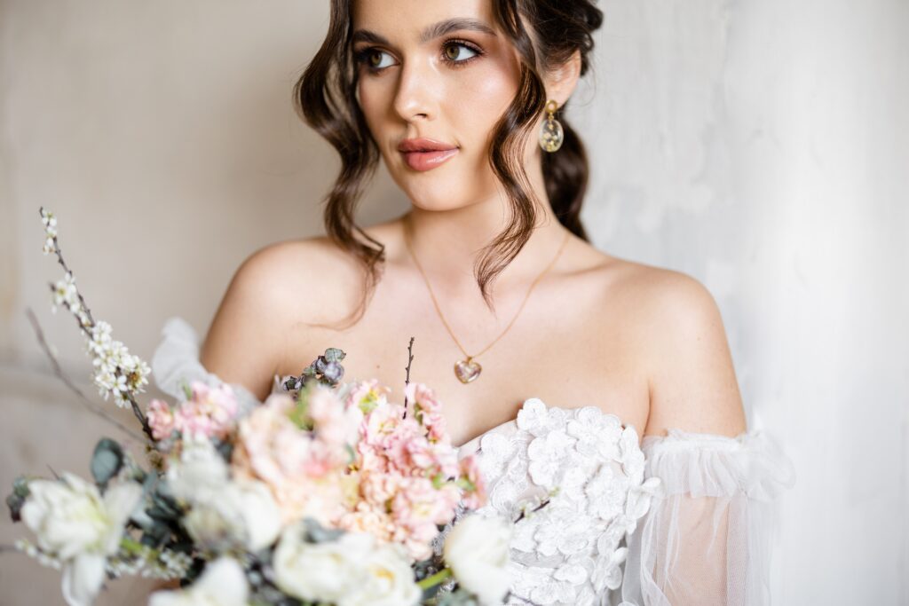 a woman in a white dress holding a bouquet of flowers