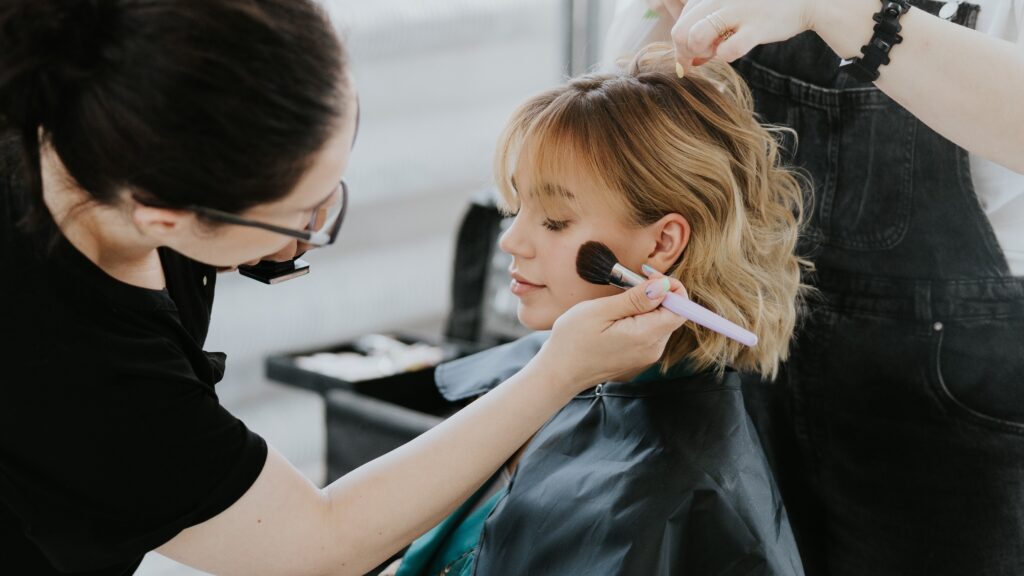 a woman getting her makeup done