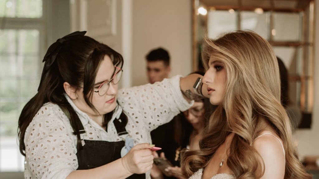 a woman getting her makeup done