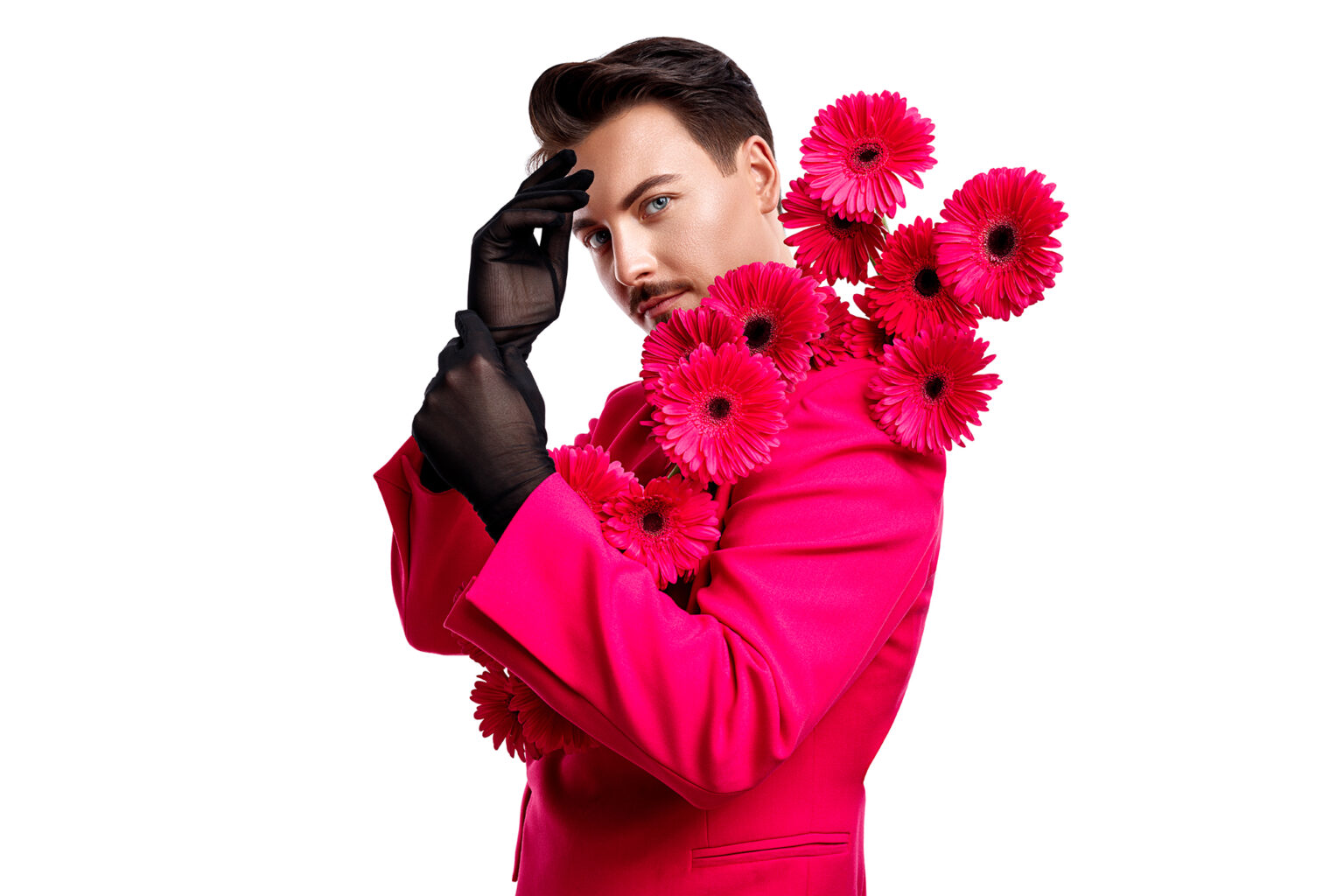 a man in a pink suit with flowers on his shoulder