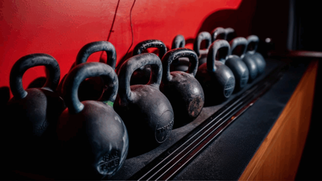 Kettlebells in front of a red wall